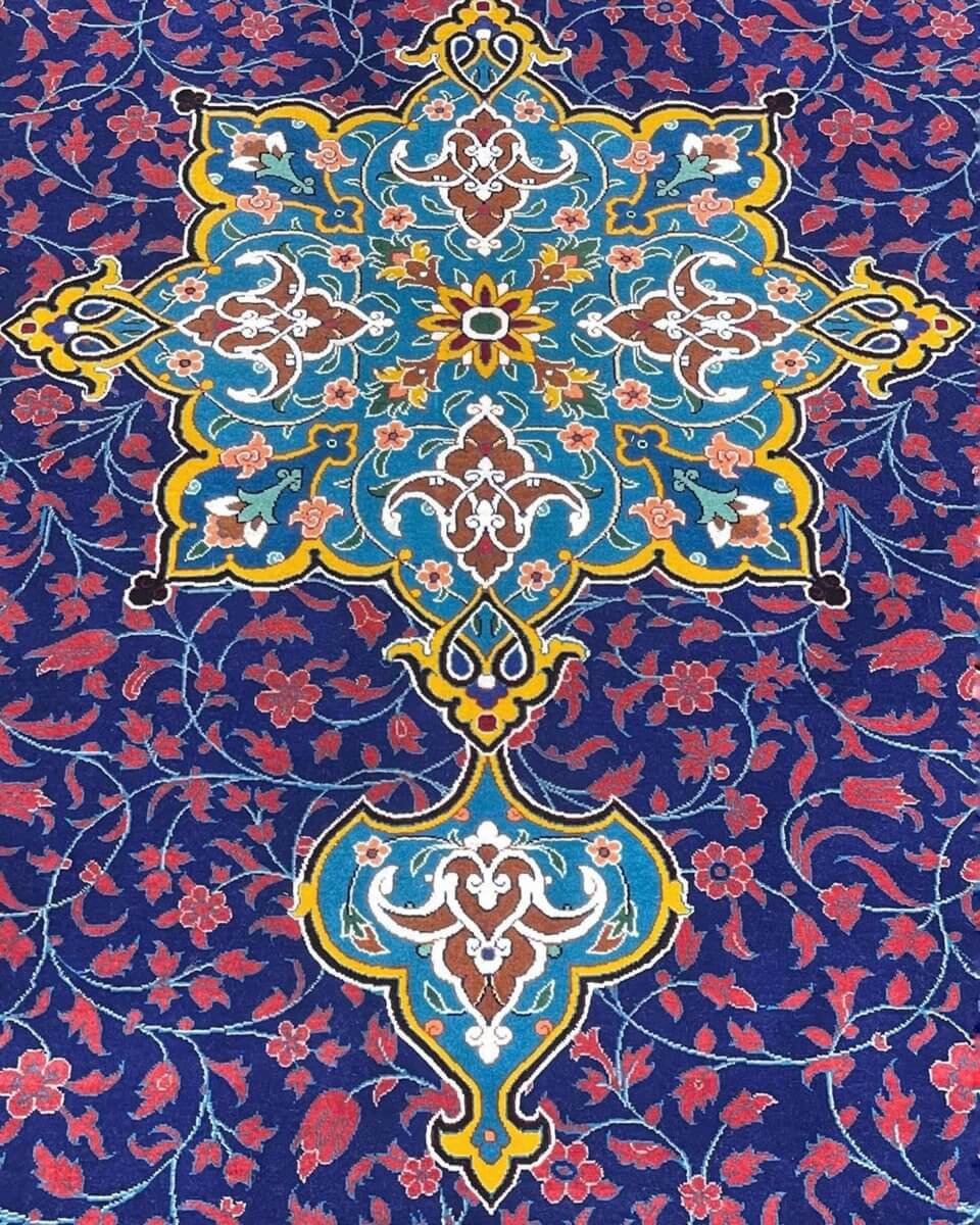 Persian Silk and Wool Rug - A close-up of the rug's border showcasing the elegant design, vibrant floral motifs, and superior craftsmanship in blue, gold, and cream tones.